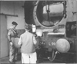 L99 after some hard running. Dave Warwick and Janice Uphill survey the damage to the paintwork on the smokebox door.