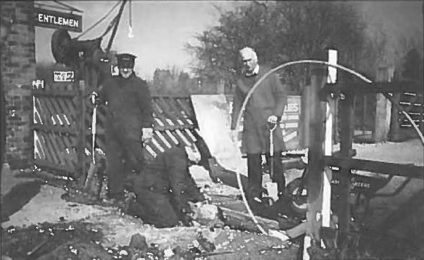 Various members in the course of their labours, extending the side of the platform exit.