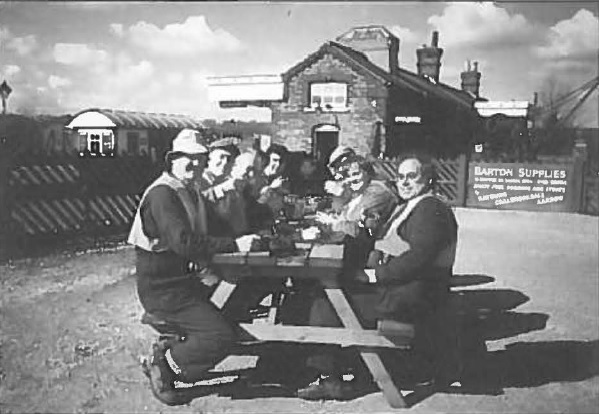 Various members in the course of their labours, extending the side of the platform exit.