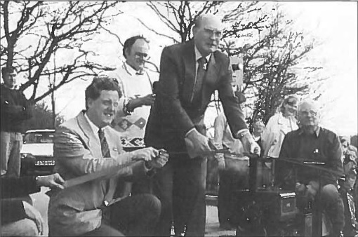 The first train about to cross the automatic level crossing at the official opening of the 
VAMES miniature railway extension on 5th April, 1995.  Pictured from left, David Brown, Editor of British Railways Modelling Magazine and 
Councillor Ray James and Chairman of VAMES Peter Booth on locomotive.