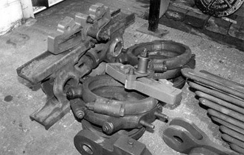 A growing collection of parts stripped off and cleaned, including crosshead